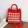 Detail of red knitted phone bag featuring white argyle texture and matching strap - Red & Cream Argyle