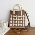 Detail of checkered knit tote bag with round handle and brown strap on a table - Coffee & Cream Argyle