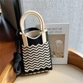 Detail of black and white wavy knit texture with smooth cream resin handle - Black & Beige Wave