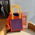 Macro detail of wave pattern knit texture on the mini crossbody bag with yellow handle - Orange & Blue Wave