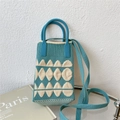 Detail of blue knitted mini crossbody bag featuring white geometric diamond patterns - Blue Rounded