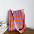 Detail of purple and orange checkered knit bag with 3D pleats and pink shoulder strap - Purple and Orange Argyle (Pink Strap)