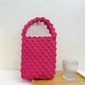 Detail of rose red knitted tote bag with unique popcorn bubble texture on wooden tray - Rose Red