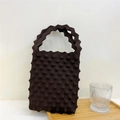 Close-up of brown popcorn knit tote bag with 3D texture and scalloped wavy handle - Dark Brown