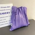 Close-up of purple pleated knit bag showing stretch fabric texture and ribbon bow detail - Purple