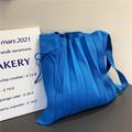 Detail of Klein blue pleated knit bag with drawstring bow and textured fabric - Sapphire Blue