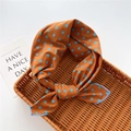 Caramel orange polka dot square scarf with blue edges in a woven basket - Polka Dot Orange (2)