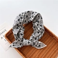 Detail of black and white geometric pattern scarf tied on a natural woven tray - Geometric Black (13)