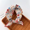 Detail of floral linen small square scarf with red edges on a woven rattan tray - Stitched Floral Beige (26)