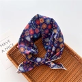 Detail of navy floral cotton linen scarf tied in a bow on a natural wicker tray - Stitched Floral Dark Blue (27)