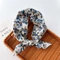 Detail of leaf print cotton linen scarf with fine stitched edges on a woven tray - Colorful Leaves Blue (29)