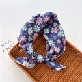 Close-up of a dark blue cotton floral headband with cat print in a woven tray - Cat Floral Purple (31)