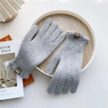 Detail of light gray knit gloves with brown leather label on wooden tray decor - Grey (Ruffle Cuff)