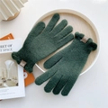 Detail of dark green knit gloves featuring scalloped cuffs and a brown leather logo patch - Dark Green (Ruffle Cuff)