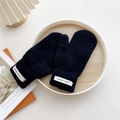 Detail of black knitted mittens with a Hand Made label on a wooden tray background - One Size / Black