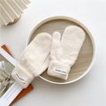 Detail of knit winter mittens in cream with thick fleece and Hand Made woven label - One Size / Apricot