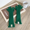 Close-up of dark green ribbed knit long gloves with white woven label on wrist - Five-Finger Style / Dark Green