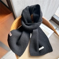 Solid black 100% wool knitted scarf with ribbed edge hanging on a wooden chair - Black
