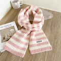 Pink and white striped knit scarf with a woven label on a wooden background - 14*150cm / Pink