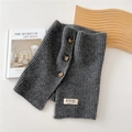 Detail of grey ribbed knit neck warmer with three dark brown buttons and brand tag - 26*30cm / Gray