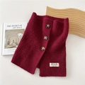 Close-up of a burgundy knitted neck gaiter with three resin buttons and a brand label - 26*30cm / Burgundy