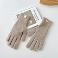 Detail of khaki ribbed knit gloves with white logo patch on a minimalist background - Beige