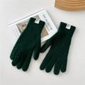 Close-up of deep green ribbed knit gloves with white logo tag on white background - Dark Green