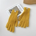 Close-up of bright yellow knit gloves with ribbed cuffs and HIL ORIGINAL brand tag - Yellow