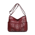Burgundy washed leather crossbody bag with multi-zipper pockets and woven texture - Red