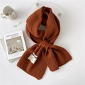 Solid brown chunky knit scarf with white label and soft vertical stripe texture - One Size / Caramel color
