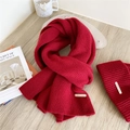 Deep red knitted scarf and beanie set with ribbed texture and metal brand tag - Red