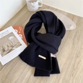 Black 100% wool knitted scarf for women featuring a minimalist golden metal brand logo - Black