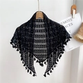 Bohemian black hollow knit triangle shawl with tassels hanging on a wooden hanger - Black