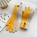Detail of yellow and beige knit gloves with ribbed texture and brown woven logo tag - One Size / Yellow Color Block