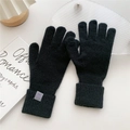 Detail of black knit gloves with ribbed cuffs showing the 70% acrylic material texture - One Size / Black