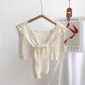 Close-up of white lace crochet hollow-out shawl with elegant tie ribbons - Creamy White