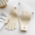 Detail of cream knit gloves showing 70% acrylic material tag and soft texture - Beige