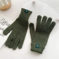 Close-up of olive green knit gloves showing 70% acrylic material tag and texture - Moss Green
