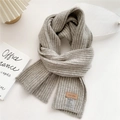 Detailed view of gray chunky knit scarf with cashmere blend and leather brand tag - Light Gray