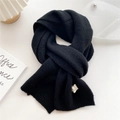 Detailed close-up of thick black knit scarf showing chunky texture and ribbed edges - 22x180cm / Black