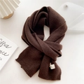 Detail of dark brown knitted scarf with soft cashmere texture and minimalist woven label - 22x180cm / Brown