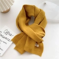 Close-up of ginger yellow knitted scarf showing soft texture and ribbed edge finish - 22x180cm / Yellow