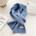 Detail of light blue knit scarf texture with handmade fashion label on white background - 22x180cm / Light Blue