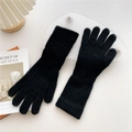 Detailed close-up of fuzzy black knit gloves with warm plush texture and ribbed wrist cuffs - Black