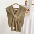 Close-up of khaki knitted cross-knot shawl with fine texture on a wooden hanger - 35*90cm / Light Green