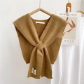 Close-up of caramel knitted crossover shawl with ribbed texture and woven label detail - 35*90cm / Camel