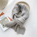 Detailed view of grey knit scarf with GRACE label texture on aesthetic background - Gray