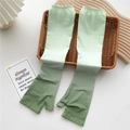 Detail of gradient green cooling sun sleeves with thumb holes in a woven tray - One Size / Gradient Army Green