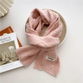 Pink knit scarf in chunky wool style with YYDS patch on a wooden tray setting - Pink