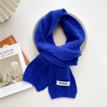 Royal blue chunky knit winter scarf with white YYDS letter label on plain background - Blue